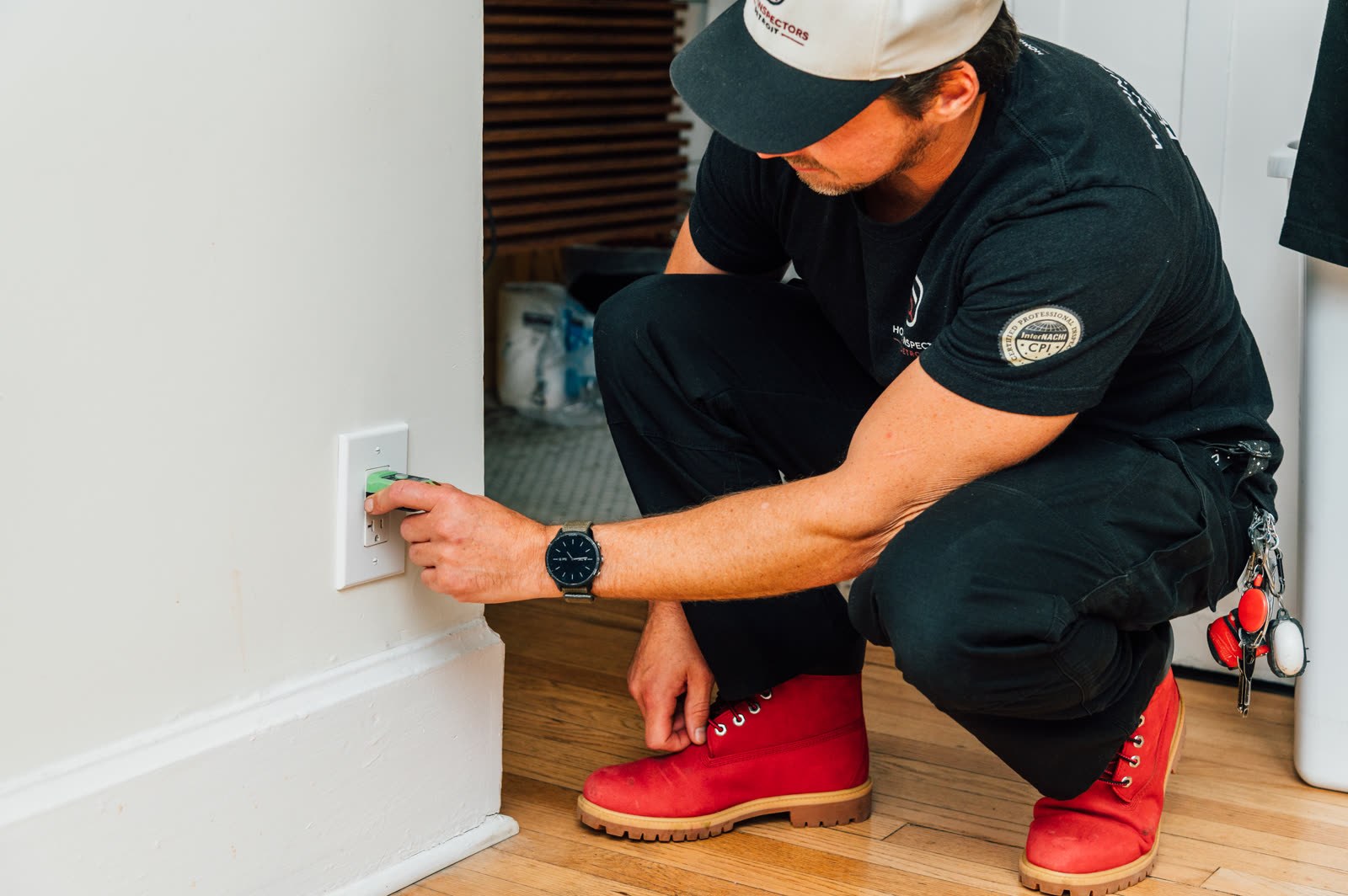 Milo Birk testing an electrical outlet during a Detroit home inspection